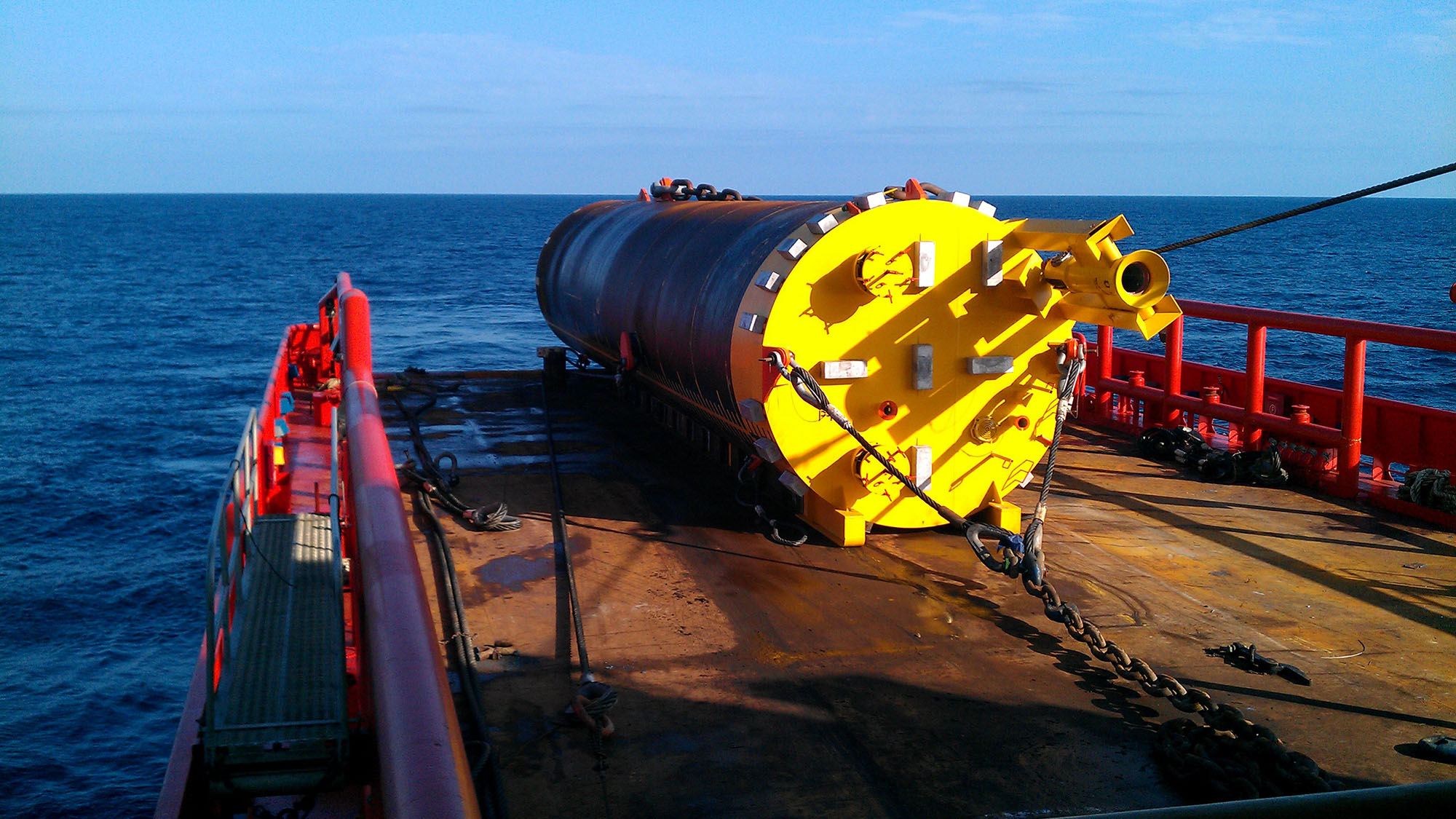 Mooring suction pile being installed from the back deck of an anchor handling vessel
