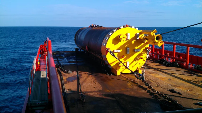Mooring suction pile being installed from the back deck of an anchor handling vessel
