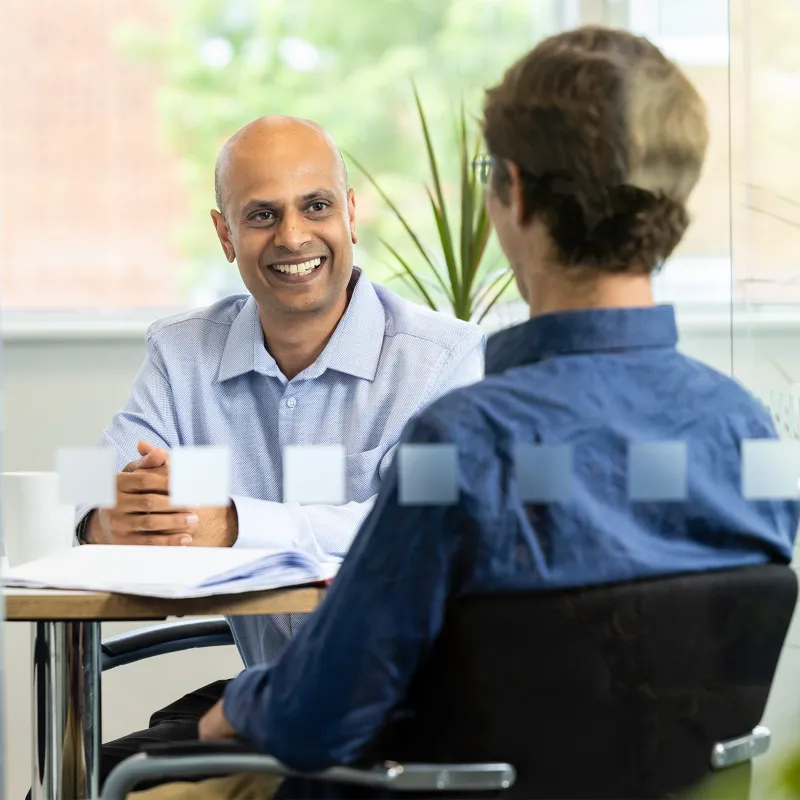 Acteon staff in the Wokingham office having a meeting in a meeting room.
