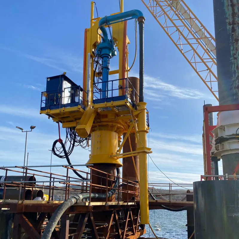 Menck’s pile-top drilling system secured to the temporary “conductor” tube via a pneumatic ‘gripper’. Temporary conductor secured within a pile gate for lateral support. 