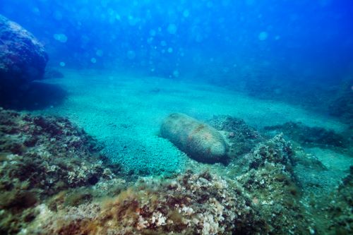 Photo of rusty metal structure lying on sea bed